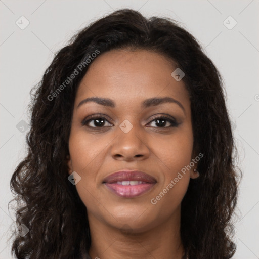 Joyful black young-adult female with long  brown hair and brown eyes