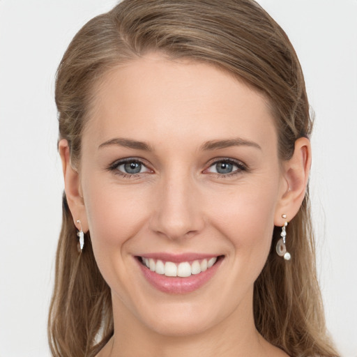 Joyful white young-adult female with long  brown hair and grey eyes