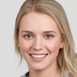 Joyful white young-adult female with long  brown hair and blue eyes