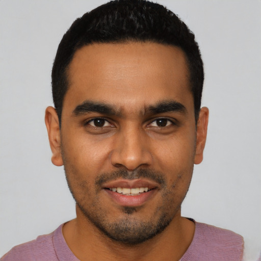 Joyful latino young-adult male with short  black hair and brown eyes
