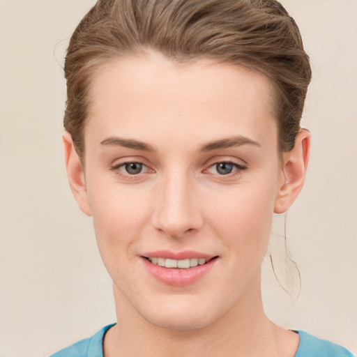 Joyful white young-adult female with short  brown hair and grey eyes