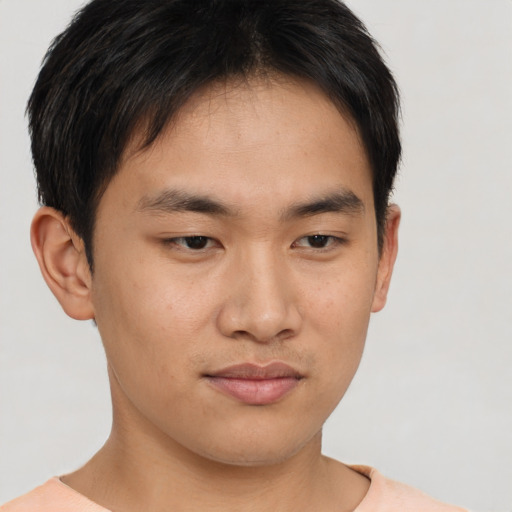 Joyful asian young-adult male with short  brown hair and brown eyes
