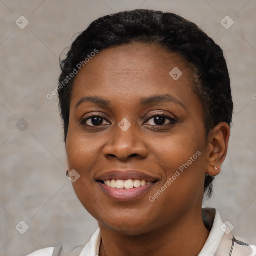 Joyful black young-adult female with short  brown hair and brown eyes