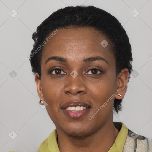 Joyful black young-adult female with short  black hair and brown eyes