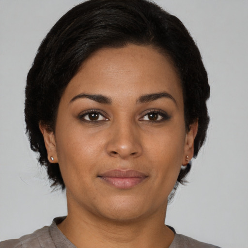 Joyful latino young-adult female with short  brown hair and brown eyes
