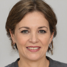 Joyful white adult female with medium  brown hair and grey eyes
