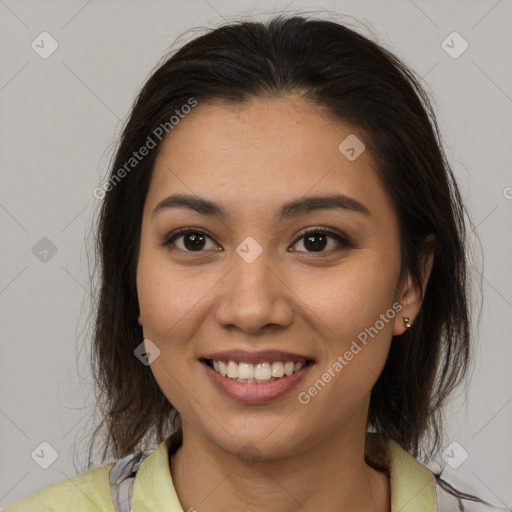 Joyful latino young-adult female with medium  brown hair and brown eyes