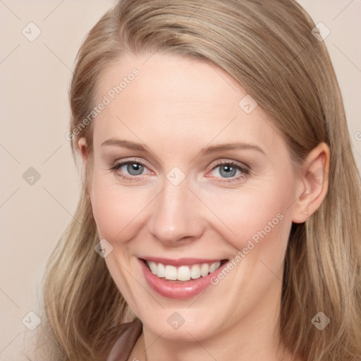 Joyful white young-adult female with long  brown hair and grey eyes