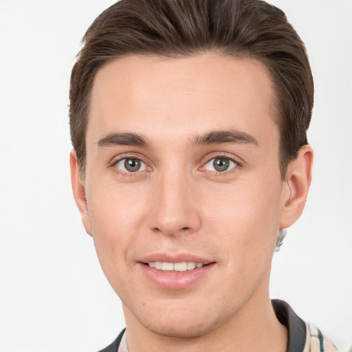 Joyful white young-adult male with short  brown hair and brown eyes