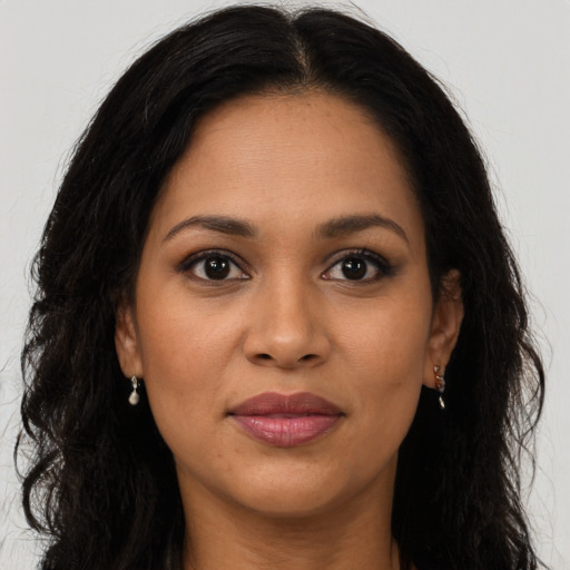 Joyful latino young-adult female with long  brown hair and brown eyes