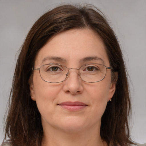 Joyful white adult female with long  brown hair and brown eyes