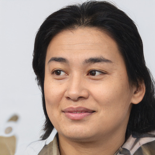 Joyful asian adult female with medium  brown hair and brown eyes