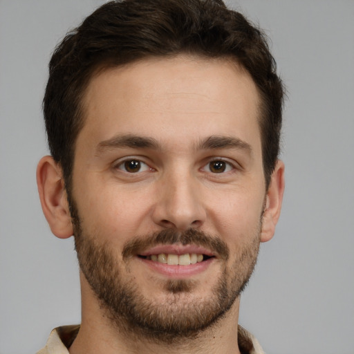 Joyful white young-adult male with short  brown hair and brown eyes