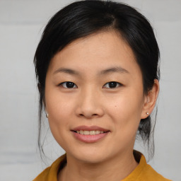 Joyful asian young-adult female with medium  brown hair and brown eyes