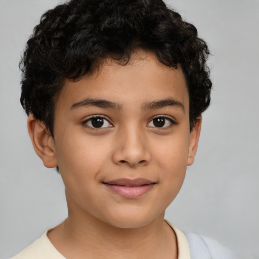 Joyful latino child male with short  brown hair and brown eyes