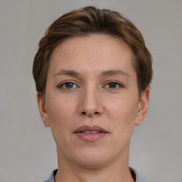 Joyful white young-adult female with short  brown hair and grey eyes