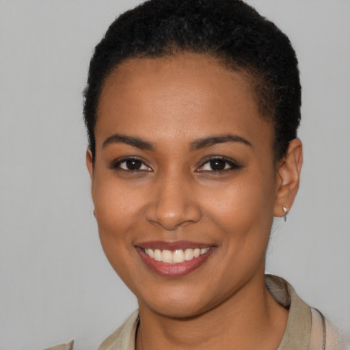 Joyful latino young-adult female with short  brown hair and brown eyes