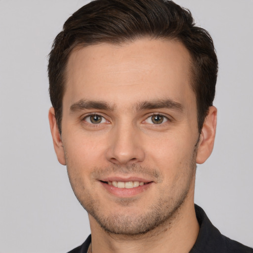 Joyful white young-adult male with short  brown hair and brown eyes