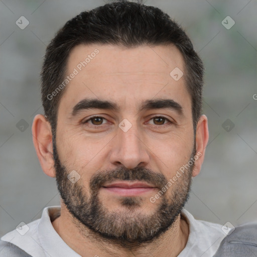 Joyful white adult male with short  black hair and brown eyes