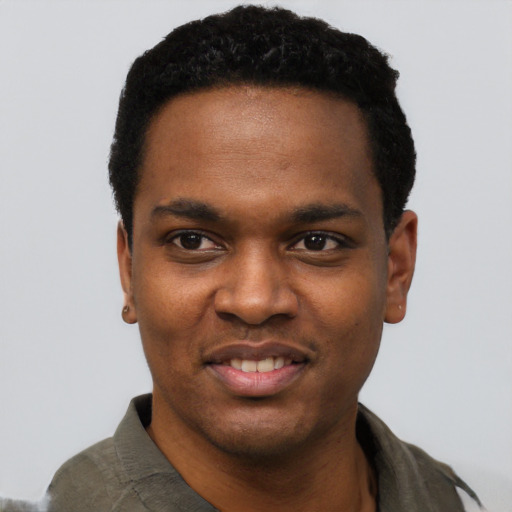 Joyful black young-adult male with short  black hair and brown eyes