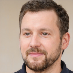 Joyful white adult male with short  brown hair and brown eyes