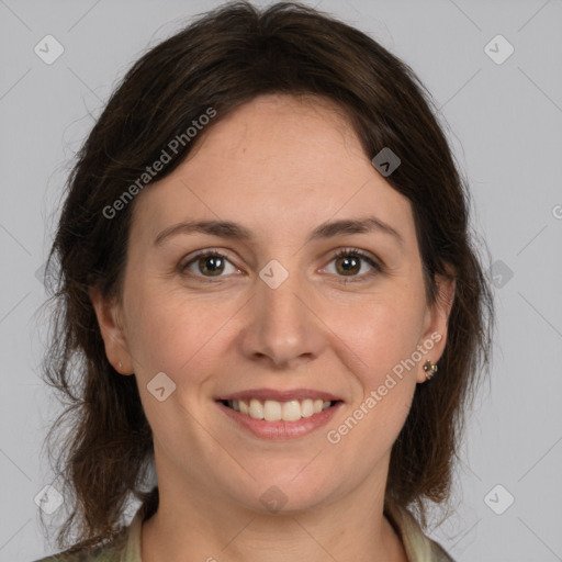 Joyful white adult female with medium  brown hair and grey eyes