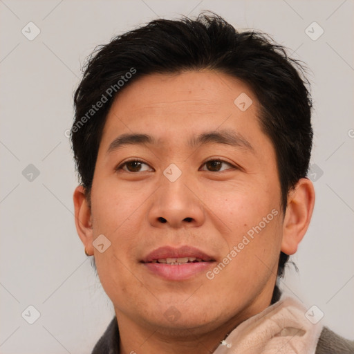 Joyful asian adult male with short  brown hair and brown eyes