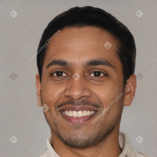 Joyful latino young-adult male with short  black hair and brown eyes