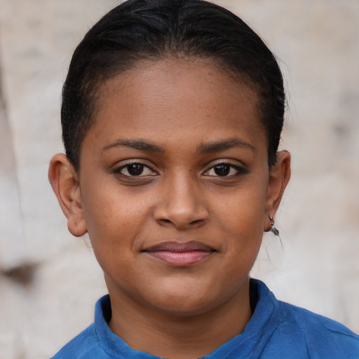 Joyful black young-adult female with short  brown hair and brown eyes
