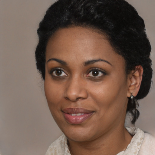 Joyful black young-adult female with medium  black hair and brown eyes