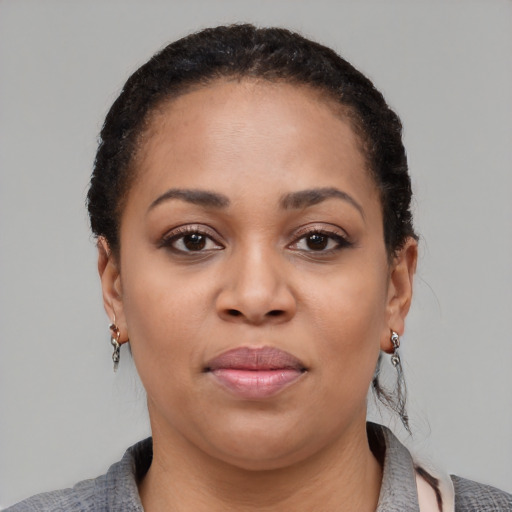 Joyful black young-adult female with short  black hair and brown eyes