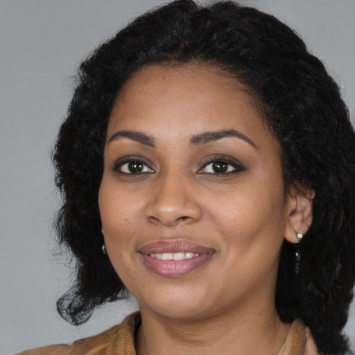 Joyful black young-adult female with medium  black hair and brown eyes