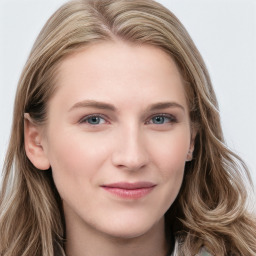 Joyful white young-adult female with long  brown hair and blue eyes