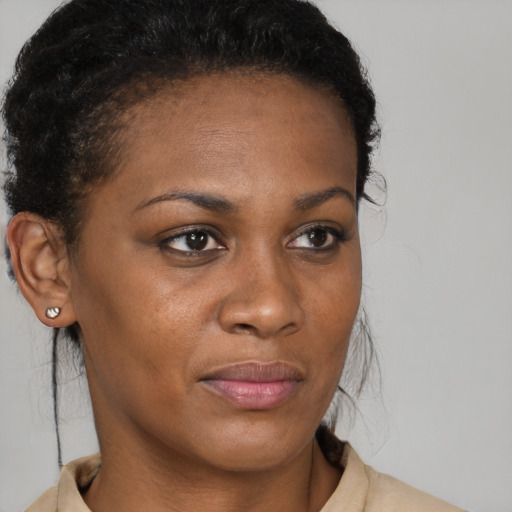 Joyful black young-adult female with medium  brown hair and brown eyes