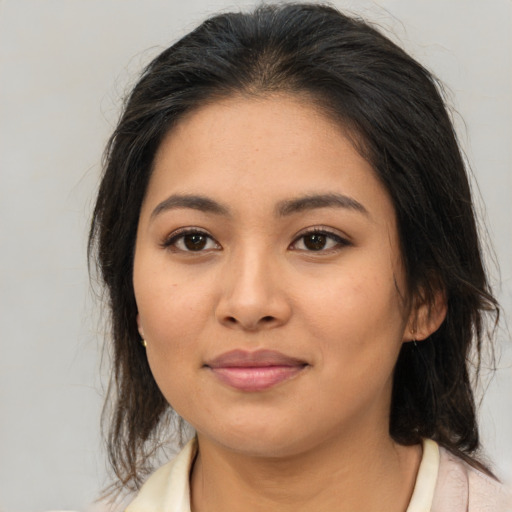 Joyful asian young-adult female with medium  brown hair and brown eyes