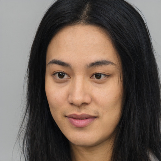 Joyful asian young-adult female with long  black hair and brown eyes
