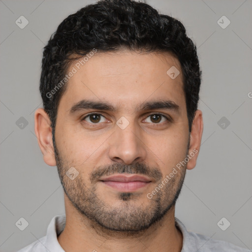 Joyful latino young-adult male with short  brown hair and brown eyes