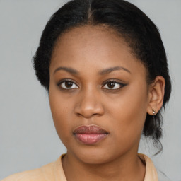 Joyful black young-adult female with medium  brown hair and brown eyes