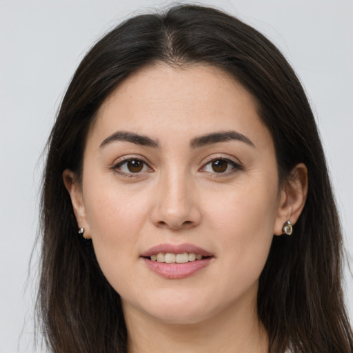 Joyful white young-adult female with long  brown hair and brown eyes