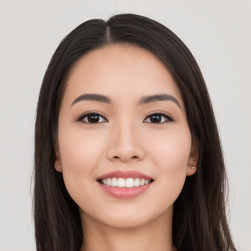 Joyful white young-adult female with long  black hair and brown eyes