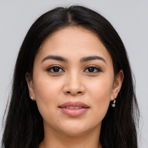Joyful latino young-adult female with long  brown hair and brown eyes