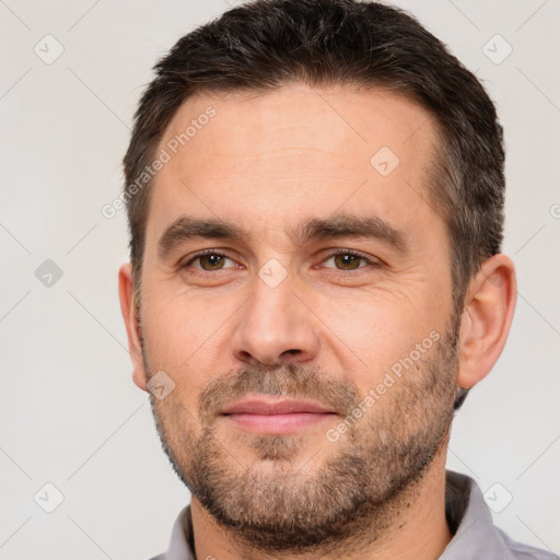 Joyful white adult male with short  brown hair and brown eyes