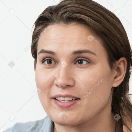 Joyful white young-adult female with medium  brown hair and grey eyes