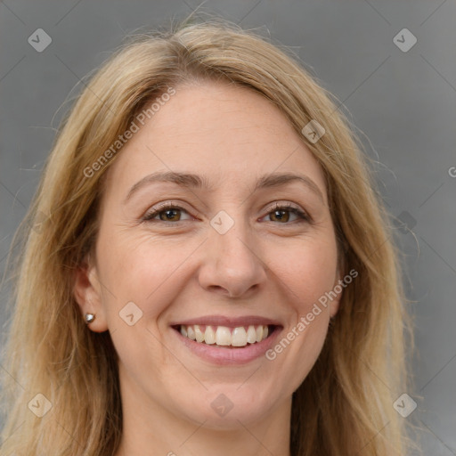 Joyful white adult female with long  brown hair and brown eyes