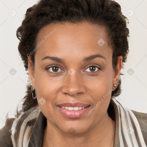 Joyful black young-adult female with long  brown hair and brown eyes