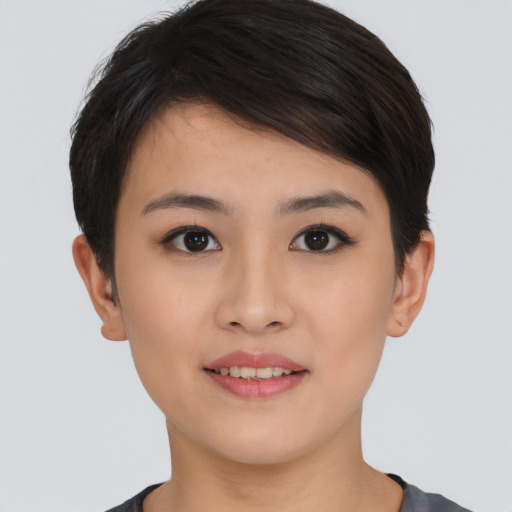 Joyful asian young-adult female with short  brown hair and brown eyes