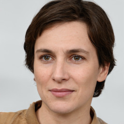 Joyful white adult female with short  brown hair and grey eyes