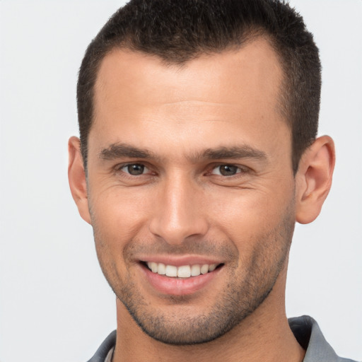 Joyful white young-adult male with short  brown hair and brown eyes