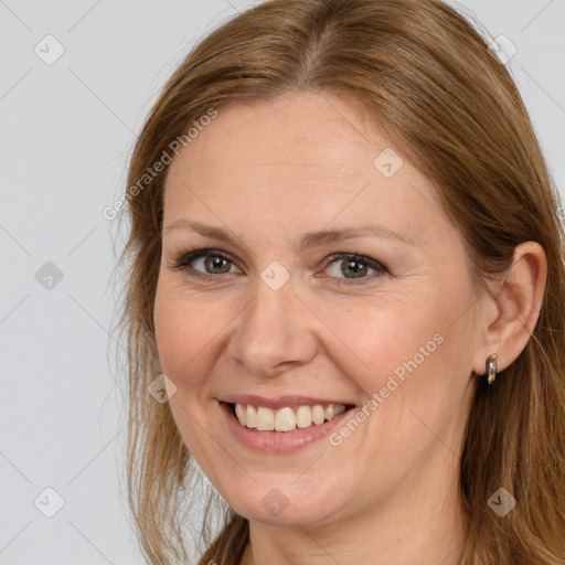 Joyful white adult female with long  brown hair and brown eyes