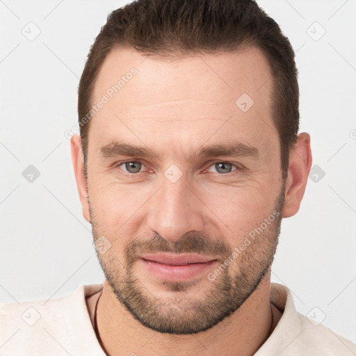 Joyful white young-adult male with short  brown hair and brown eyes